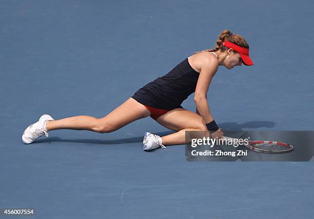 Alize Cornet of France falls down during her match against Kirsten Flipkens of Belgium on day four of 2014 Dongfeng Motor Wuhan Open at Optics Valley...
