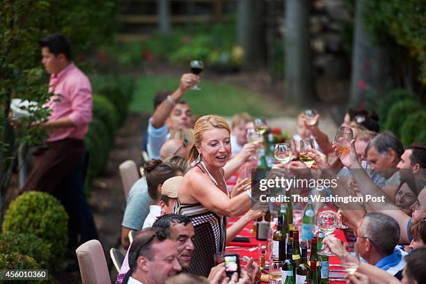 Greta De Keyser and Bart Vandaele and guests toast during an evening of entertainment and food and drink at their home in Alexandria, Virginia on...