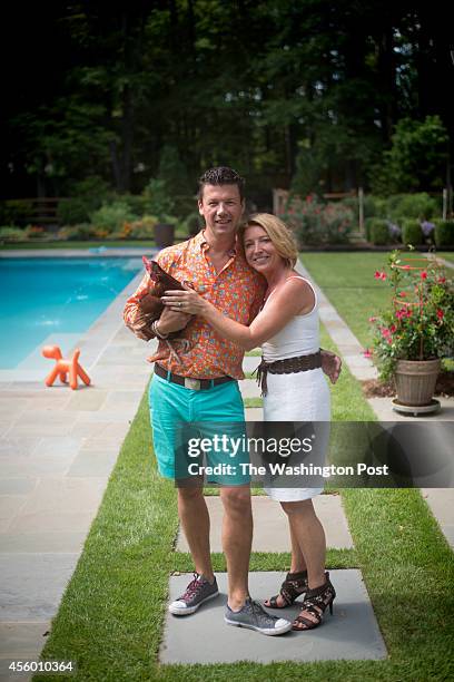 Bart Vandaele and Greta De Keyser with one of their hens at their home in Alexandria, Virginia on September 06, 2014.