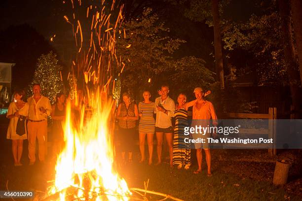 Chef Bart Vandaele enjoys a bonfire with his guests at his home in Alexandria, Virginia on September 06, 2014.