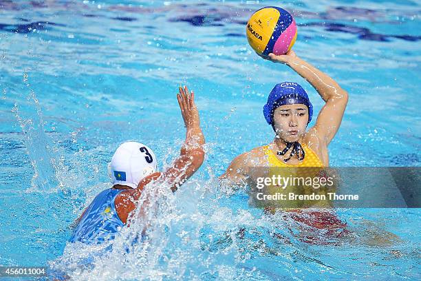 Zihan Zhao of China competes with Aizhan Akilbayeva of Kazakhstan in the Women's Single Round Robin Waterpolo during day five of the 2014 Asian Games...