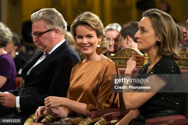 Prince Laurent, Queen Mathilde and Princess Claire of Belgium attend the Christmas concert held at the Royal Palace on December 11, 2013 in Brussels,...