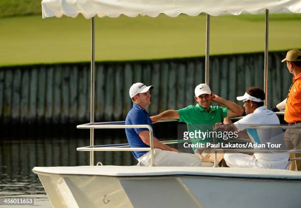 Justin Rose of England, Charl Schwartzel of South Africa and Thongchai Jaidee of Thailand ride the Amata boat from the 17th island green during day...