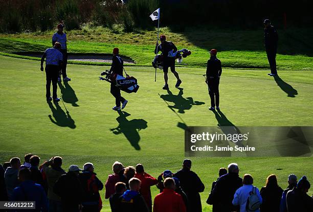United States team members walk on the 9th green during practice ahead of the 2014 Ryder Cup on the PGA Centenary course at the Gleneagles Hotel on...