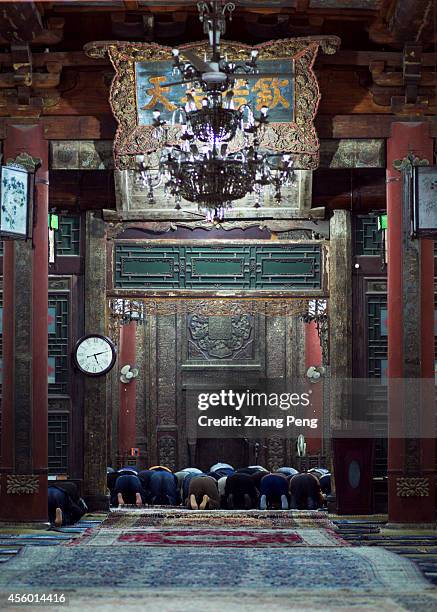 Moslems are making worship in the main hall of the Xi'an Great Mosque. The hall can hold 1000 believers to do their religious services at the same...