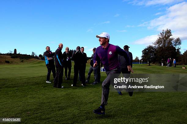 Rory McIlroy of Europe runs and smiles on the course ahead of the 2014 Ryder Cup on the PGA Centenary course at the Gleneagles Hotel on September 24,...