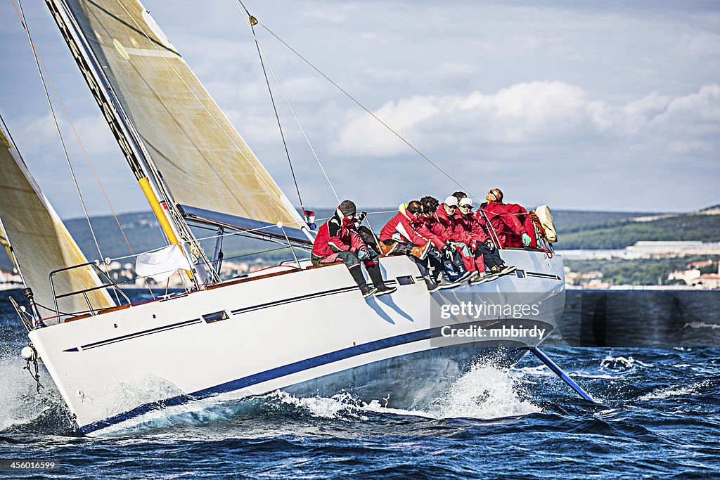 Sailing crew on sailboat during regatta