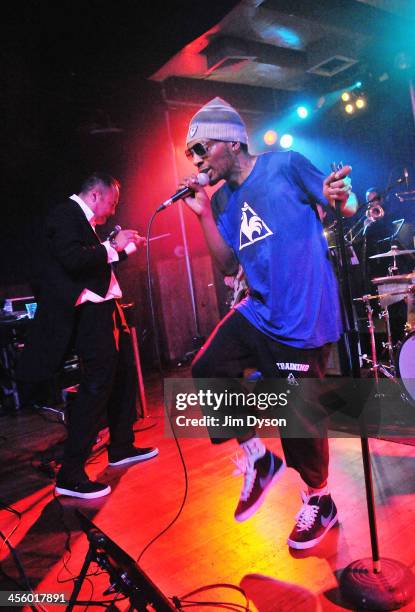 Producer Dan the Automator and rapper Del the Funky Homosapien of alternative hip hop supergroup Deltron 3030 perform live on stage with a 16-piece...