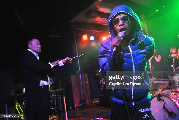 Producer Dan the Automator and rapper Del the Funky Homosapien of alternative hip hop supergroup Deltron 3030 perform live on stage with a 16-piece...