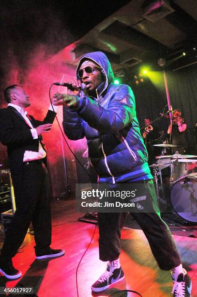 Producer Dan the Automator and rapper Del the Funky Homosapien of alternative hip hop supergroup Deltron 3030 perform live on stage with a 16-piece...