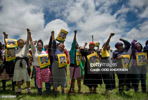 People dance and chant slogans as African National Congress activists play music and hand out posters of the late former President of South Africa...