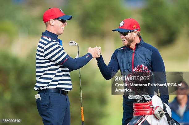 Hunter Mahan of the United States fist bumps his caddie John Wood during a practice round for the 40th Ryder Cup at Gleneagles, on September 24, 2014...