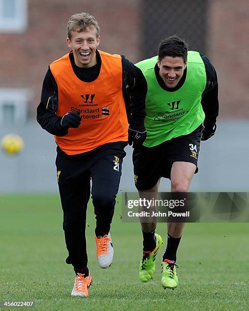 Lucas Leiva and Martin Kelly of Liverpool in action during a training session at Melwood Training Ground on December 13, 2013 in Liverpool, England.