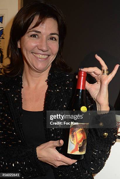 Catherine Houard poses with a bottle of Mercurey 2012 'Or Rouge' Cuvee Piero Grommelynck wine the label is decorated by Pablo Picasso during the...