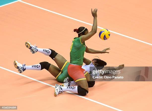 Berthrade Simone Flore Bikatal and Marthe Armelle Bilee Etoga of Cameroon makes a save during the FIVB Women's World Championship pool B match...