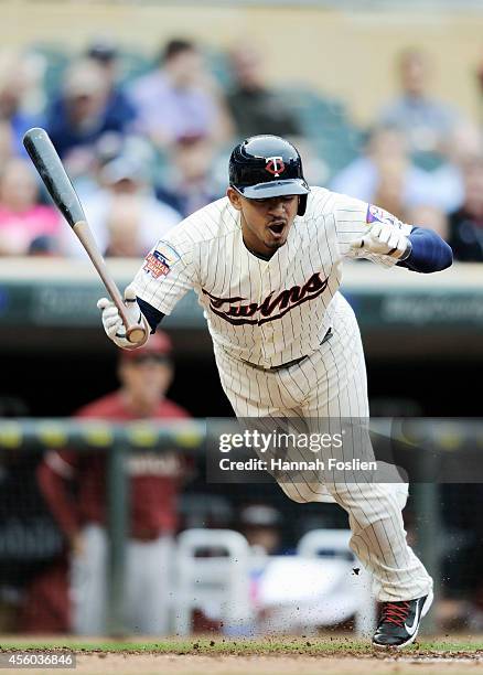 Eduardo Escobar of the Minnesota Twins reacts to being hit in the foot by a pitch during the second inning of the game against the Arizona...