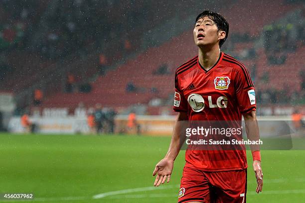 Heung Min Son of Leverkusen celebrates after scoring the opening goal during the Bundesliga match between Bayer 04 Leverkusen and FC Augsburg at...