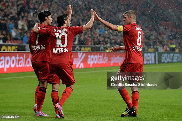 Heung Min Son of Leverkusen celebrates with team mates after scoring the opening goal during the Bundesliga match between Bayer 04 Leverkusen and FC...