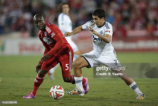 Jair Benitez of FC Dallas and Sebastian Fernandez of Vancouver FC fight for control of the ball at Toyota Stadium in Frisco on September 14, 2014 in...