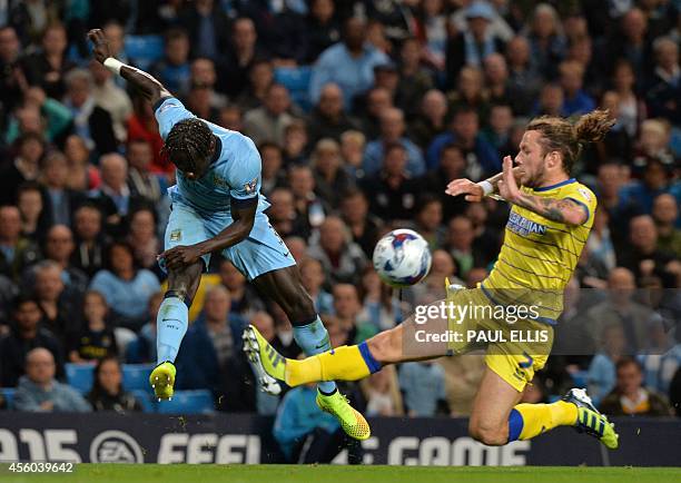 Manchester City's French defender Bacary Sagna vies with Sheffield Wednesday's Scottish striker Stevie May during the English League Cup third round...