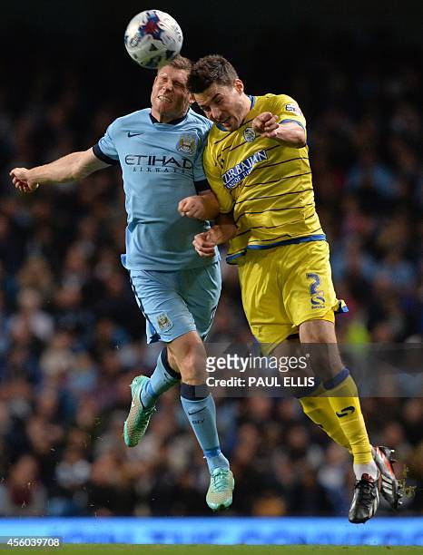Sheffield Wednesday's English defender Lewis Buxton vies with Manchester City's English midfielder James Milner during the English League Cup third...