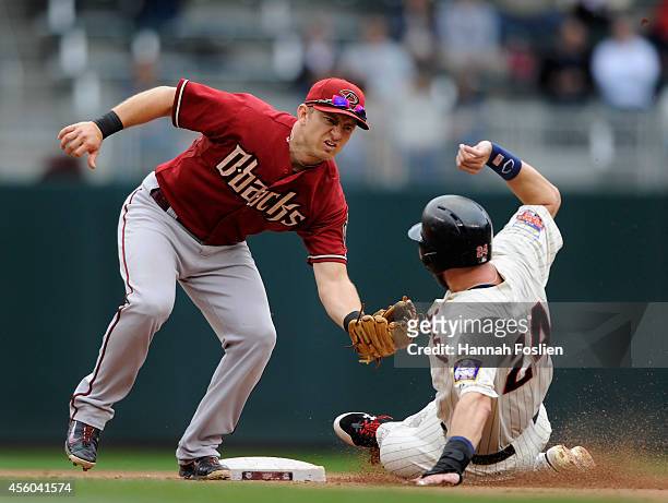 Cliff Pennington of the Arizona Diamondbacks tags out Trevor Plouffe of the Minnesota Twins at second base during the fifth inning of the game on...