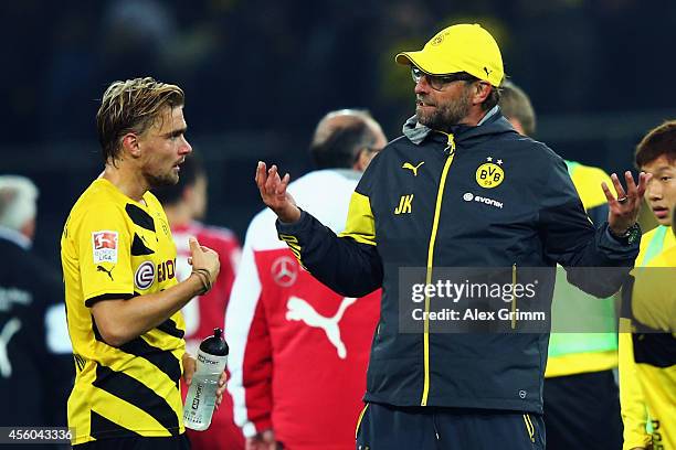 Head coach Juergen Klopp of Dortmund talks to Marcel Schmelzer after the Bundesliga match between Borussia Dortmund and VfB Stuttgart at Signal Iduna...