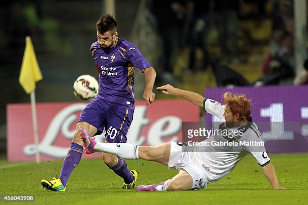 Nenad Tomovic of ACF Fiorentina fights for the ball with Davide Biondini of US Sassuolo Calcio during the Serie A match between ACF Fiorentina and US...