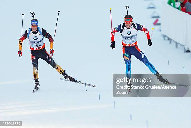 Simon Schempp of Germany takes 2nd place, Anton Shipulin of Russia takes 1st place during the IBU Biathlon World Cup Men's Relay on December 13, 2013...