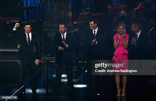 Rory McIlroy , Graeme McDowell , Martin Kaymer and Sergio Garcia of Europe with Katharina Boehm pose on stage during the 2014 Ryder Cup Gala Concert...