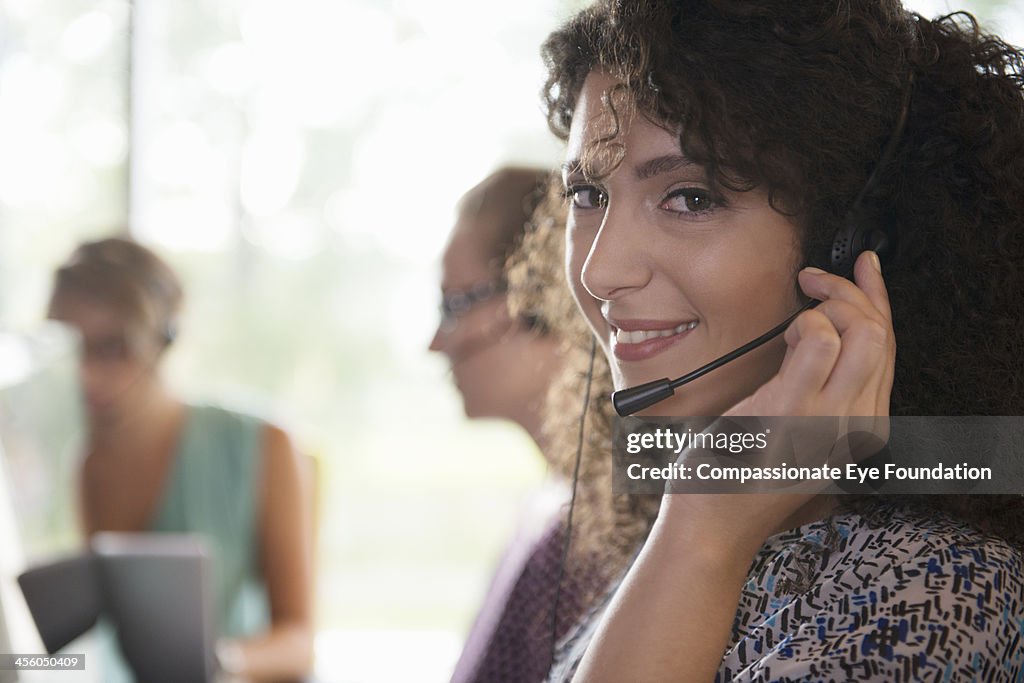 Business people with headsets working in office