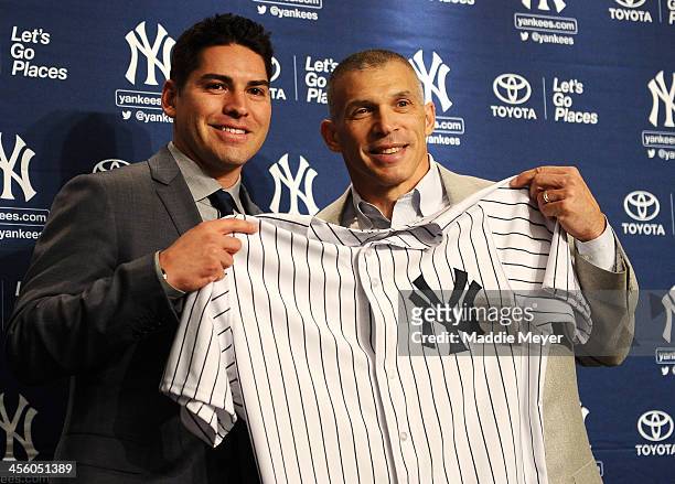 Centerfielder Jacoby Ellsbury and New York Yankees Manager Joe Girardi stand for a photo during Ellsbury's introductory press conference at Yankee...