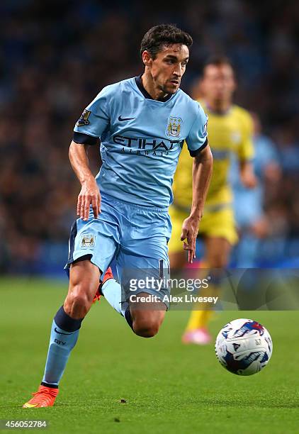Jesus Navas of Manchester City runs with the ball during the Capital One Cup Third Round match between Manchester City and Sheffield Wednesday at...