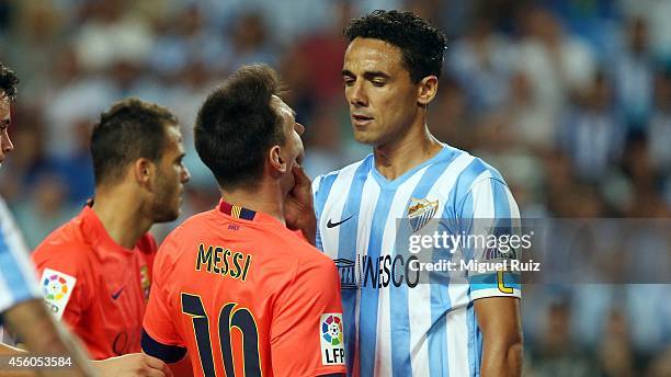 Lionel Messi of FC Barcelona gets fouled by Welingon of Malaga CF during the La Liga match between Malaga CF and FC Barcelona at La Rosaleda Stadium...