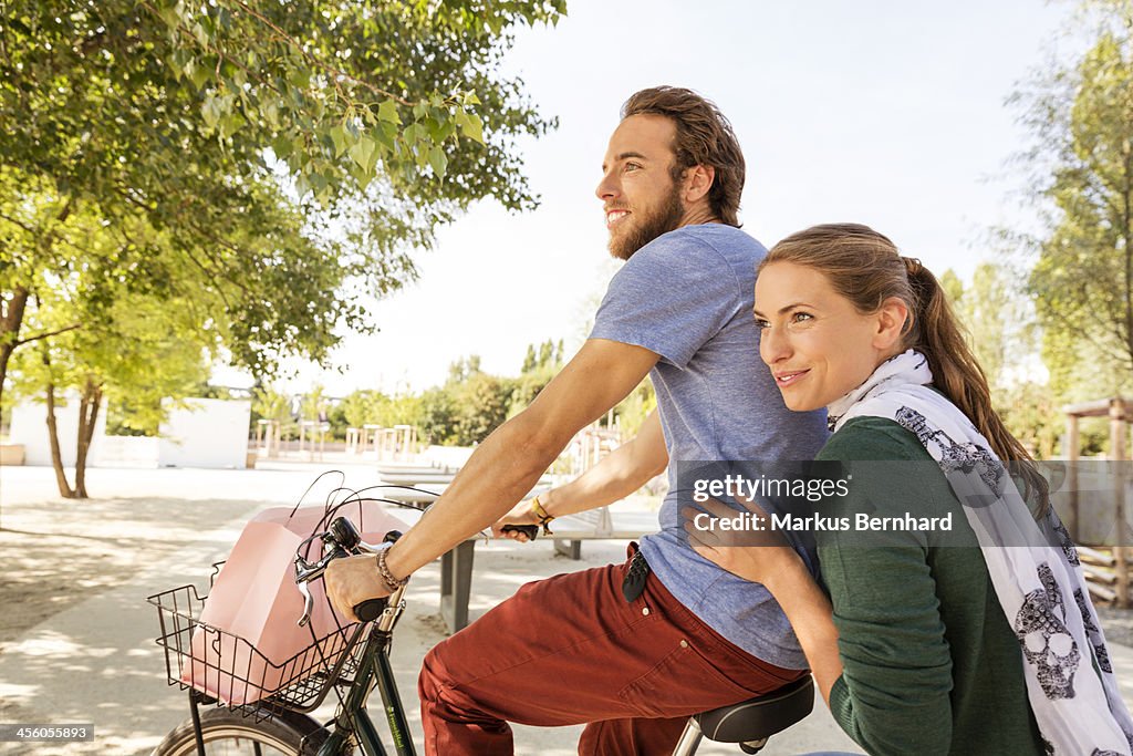 Couple share a ride on bicycle