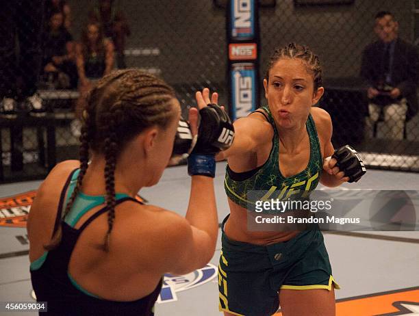 Team Pettis fighter Jessica Penne punches team Melendez fighter Lisa Ellis during filming of season twenty of The Ultimate Fighter on July 15, 2014...