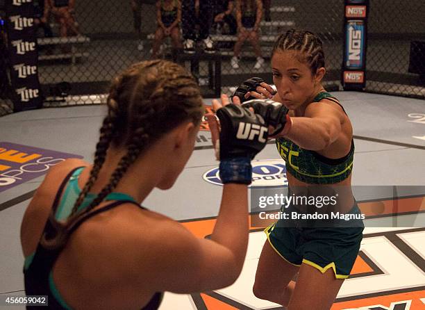 Team Pettis fighter Jessica Penne punches team Melendez fighter Lisa Ellis during filming of season twenty of The Ultimate Fighter on July 15, 2014...