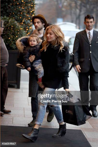 Sienna Miller, Tom Sturridge and daughter Marlowe Sturridge are seen on December 13, 2013 in Paris, France.