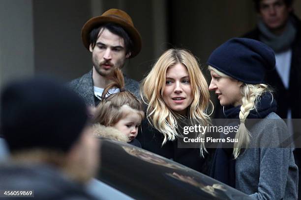 Sienna Miller, Tom Sturridge and daughter Marlowe Sturridge are seen on December 13, 2013 in Paris, France.