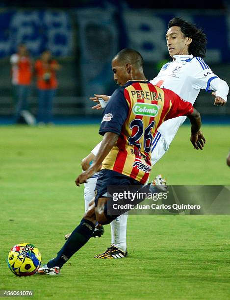 Fabio Rodríguez of Aguilas Doradas struggles for the ball with Rafael Robayo of Millonarios during a match between Aguilas Doradas and Millonarios as...