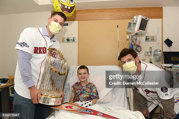 The Red Sox's Ryan Lavarnway and Craig Breslow visit with Devon at Boston Children's Hospital on December 13, 2013 in Boston, Massachusetts.
