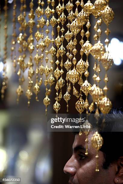 Golf jewllery is pictured at the Dubai Gold Souk on September 25, 2014 in Dubai, United Arab Emirates.