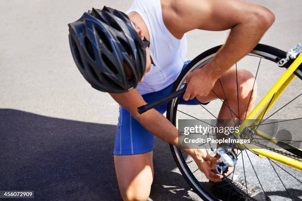 changing his bike tyre - air pump stock pictures, royalty-free photos & images