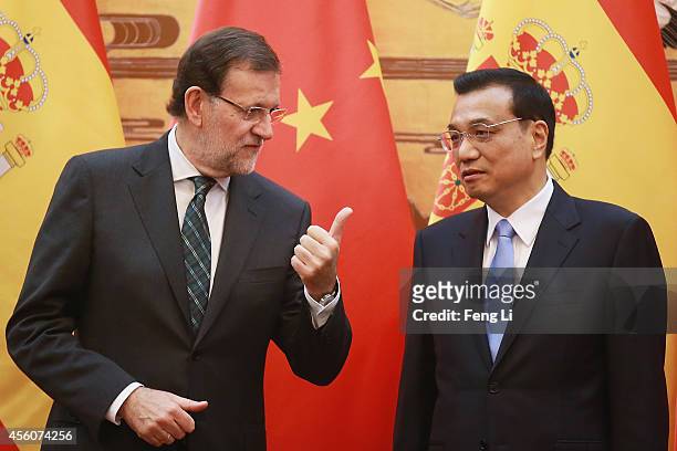 Spanish Prime Minister Mariano Rajoy talks with Chinese Premier Li Keqiang during a signing ceremony in the Great Hall of the People on September 25,...