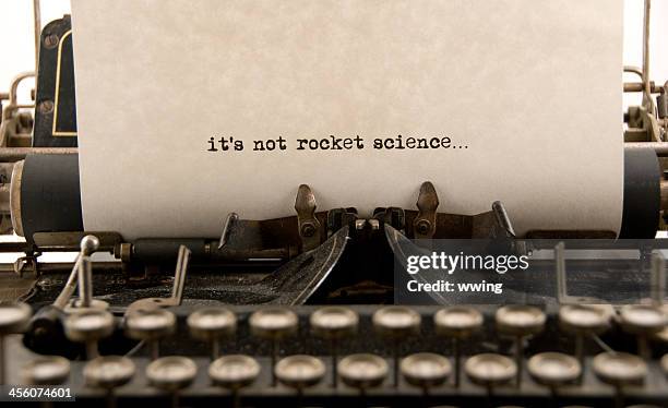 it's not rocket science... - typewriter stockfoto's en -beelden