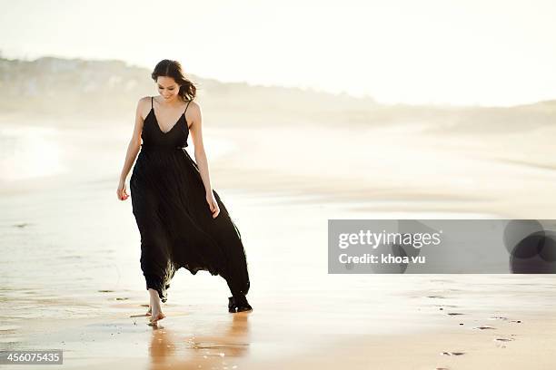 walking on sand - black dress stock pictures, royalty-free photos & images