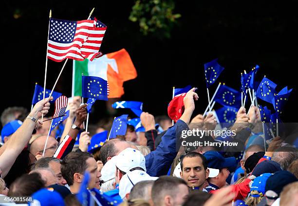 Flags from the United States and Europe are waved prior to the Opening Ceremony ahead of the 40th Ryder Cup at Gleneagles on September 25, 2014 in...