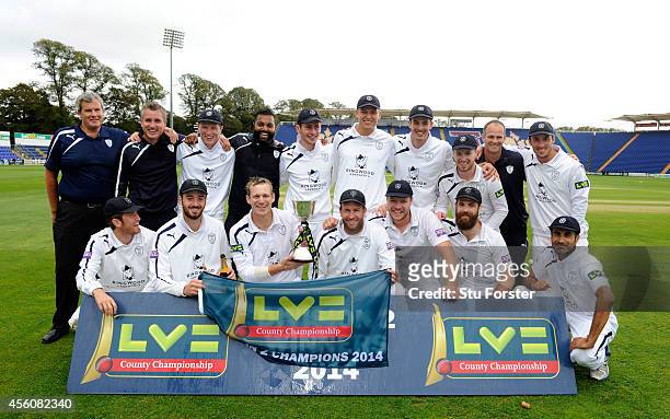 The victorious Hampshire team and staff celebrate with the trophy after winning the Division Two Championship after beating Glamorgan on day three of...