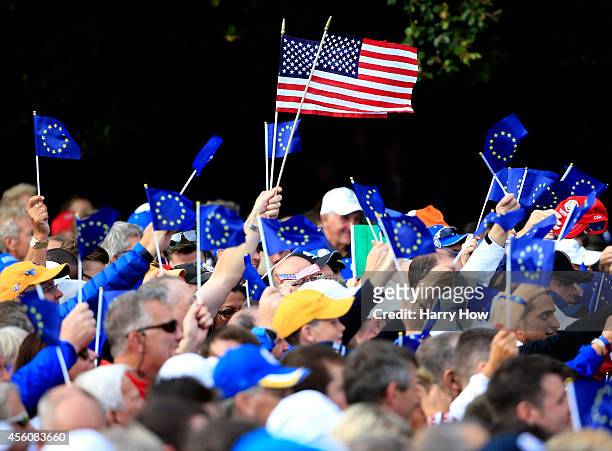 Flags from the United States and Europe are waved prior to the Opening Ceremony ahead of the 40th Ryder Cup at Gleneagles on September 25, 2014 in...
