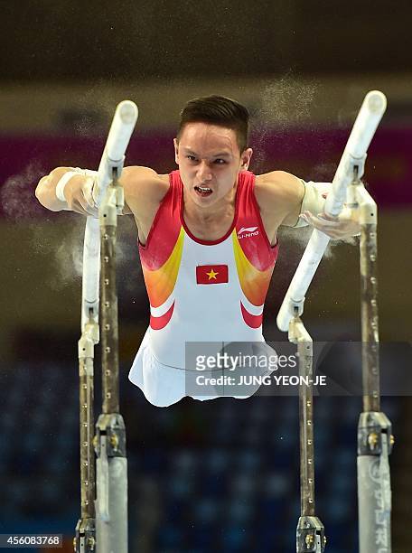 Vietnam's Phuong Thanh Dinh performs in the men's parallel bars final of the artistic gymnastics event during the 2014 Asian Games at the Namdong...